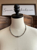 Graduated sterling silver bead necklace with short ball chain, close neckline view