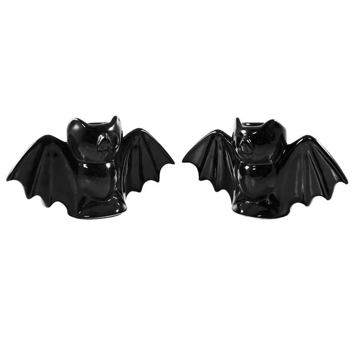 Black bat candlestick holders come in a set of two, and each holds a standard taper candle. CANDLES NOT INCLUDED.