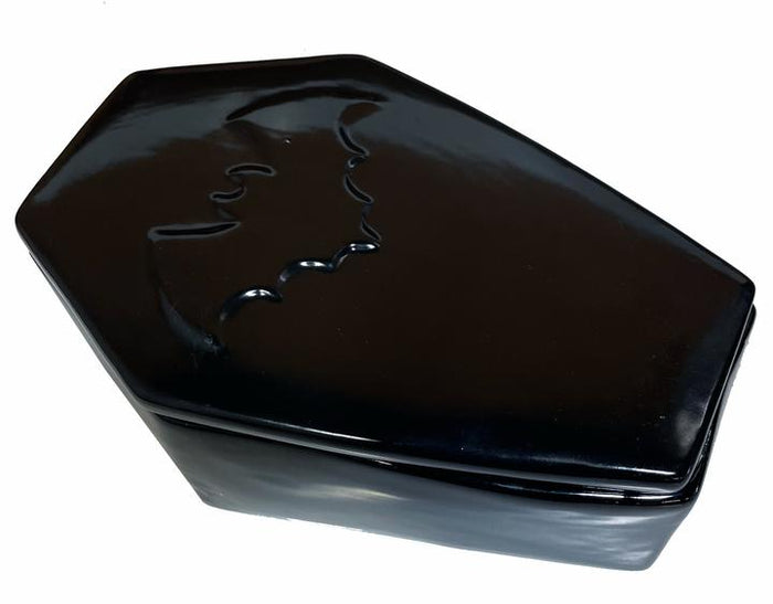 Coffin shaped black box made from ceramic and has a molded bat on the lid.