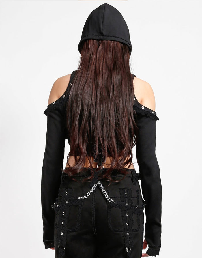 back of Black hoodie with gothic Lolita details. Hoodie has long sleeves that have thumb holes and black lace around the hands. Shoulders are open, and have edges of black on black lace details, as well as silver rivet details around the edge. Front of hoodie zips up, and has black on black lacey lace-up panels on right and left of zipper. Hoodie has black hood.
