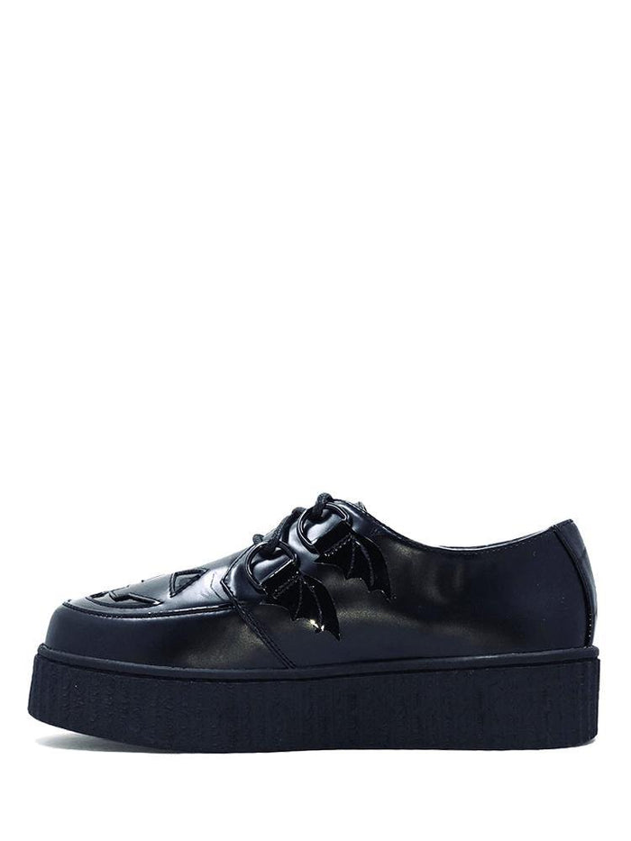 side of Black vegan leather creeper shoes with Jack-O-Lantern cut out face on top of shoe. Shoe has black round laces. Shoes are 100% vegan leather and black rubber outsole.