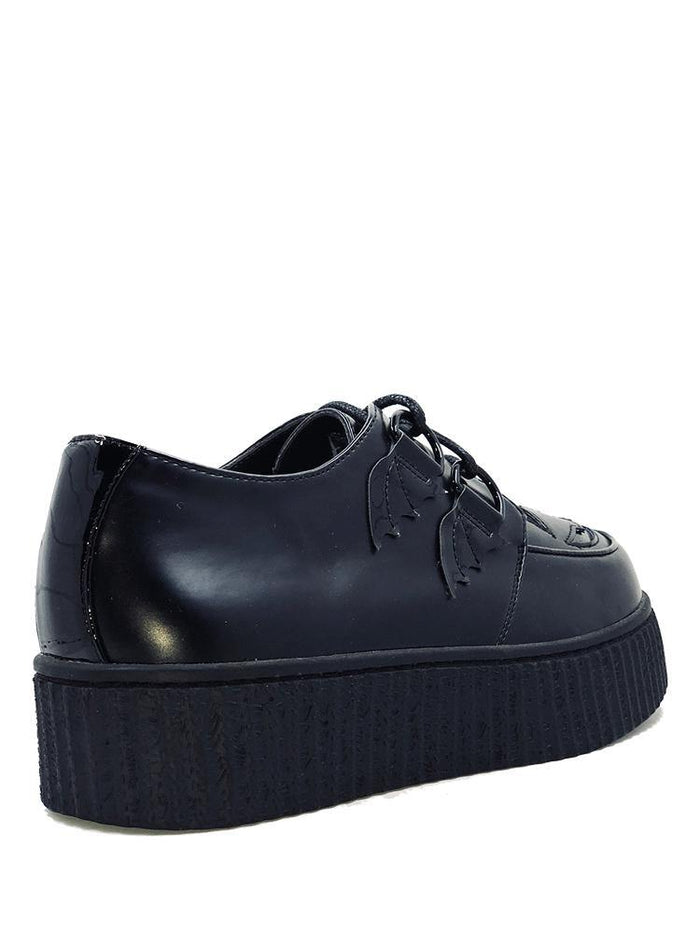 back of Black vegan leather creeper shoes with Jack-O-Lantern cut out face on top of shoe. Shoe has black round laces. Shoes are 100% vegan leather and black rubber outsole.