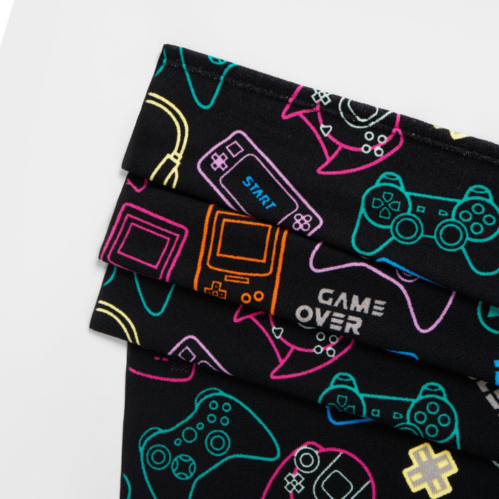 Close-up of console gamer design on black microfibre beach towel, children’s gaming print detail