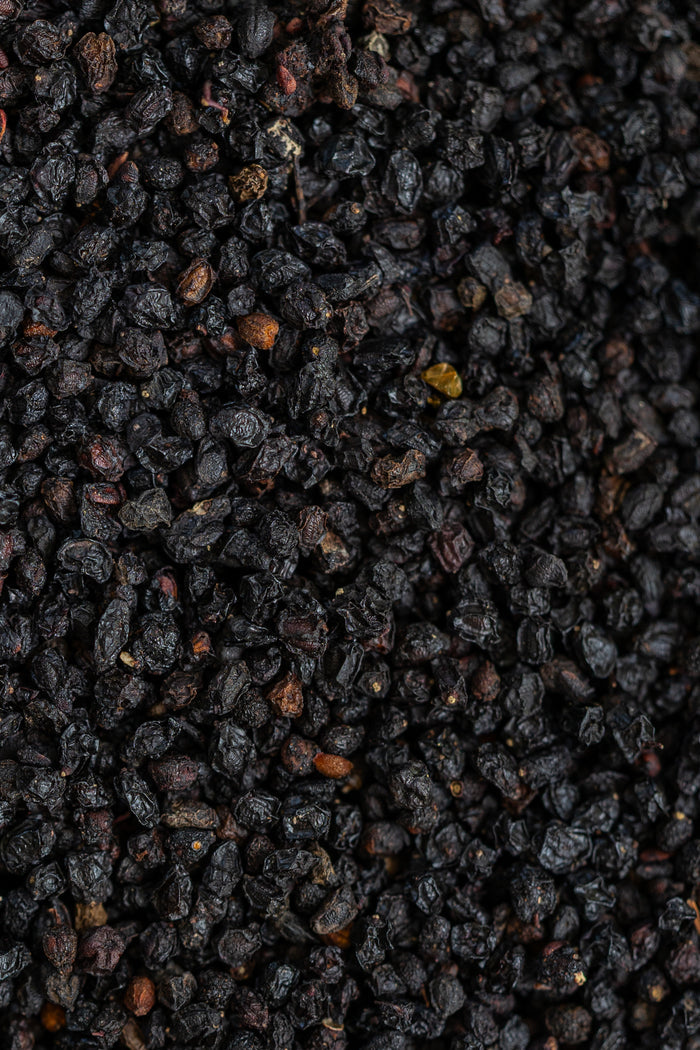 Close-up of dark-colored seeds or small stones