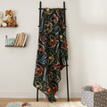 gaming fleece throw blanket displayed on hanger in cosy home setting