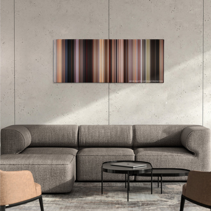 Jackie Brown color palette canvas on a concrete wall above a gray sectional sofa