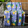 lemon print fleece throw draped over garden bench for outdoor relaxation