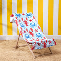 Lobster print beach towel draped over deckchair with blue coastal design