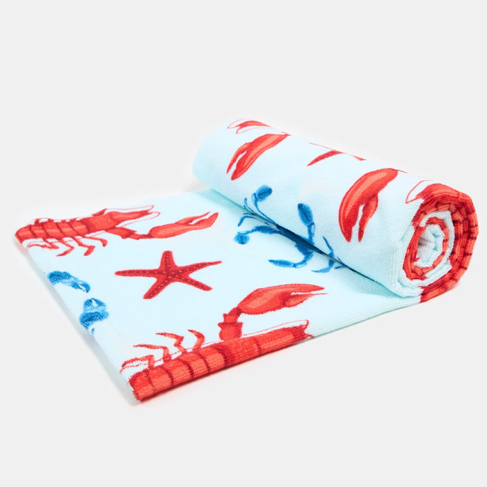 Rolled lobster print beach towel showing vibrant blue colour and pattern