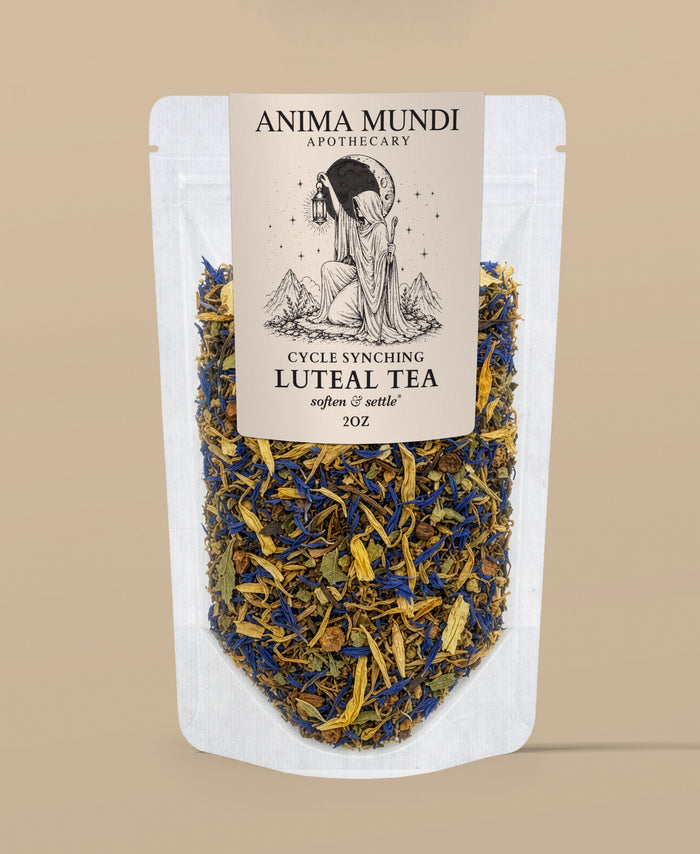 A stand-up pouch of Anima Mundi Apothecary Cycle Synching Luteal Tea, featuring a cream-colored label with black text and an illustration of a woman holding a moon lamp, set against a solid beige background.