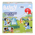 Front of the Moose Toys Bluey Keepy Uppy Game box shows cartoon characters outdoors with a red balloon, character paddles, kids playing the motorized game, and a small parts warning. For ages 4+, 2-3 players. Brand: Moose Toys.
