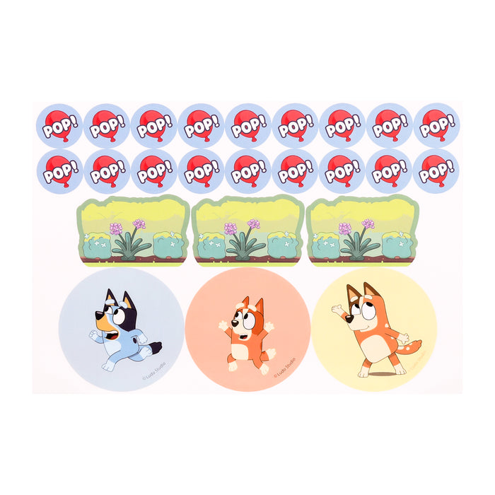 This sticker sheet from Moose Toys Bluey Keepy Uppy Game features POP! text speech bubbles, three rectangle stickers with green scenery, and three round stickers with cartoon dogs on yellow, orange, and blue backgrounds.