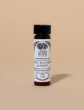 Bottle of Anima Mundi Night Blooming Jasmine essential oil on a beige background