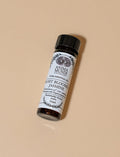 Anima Mundi essential oil bottle on a beige background