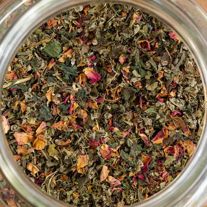 Close-up of a jar filled with dried herbs and flowers.