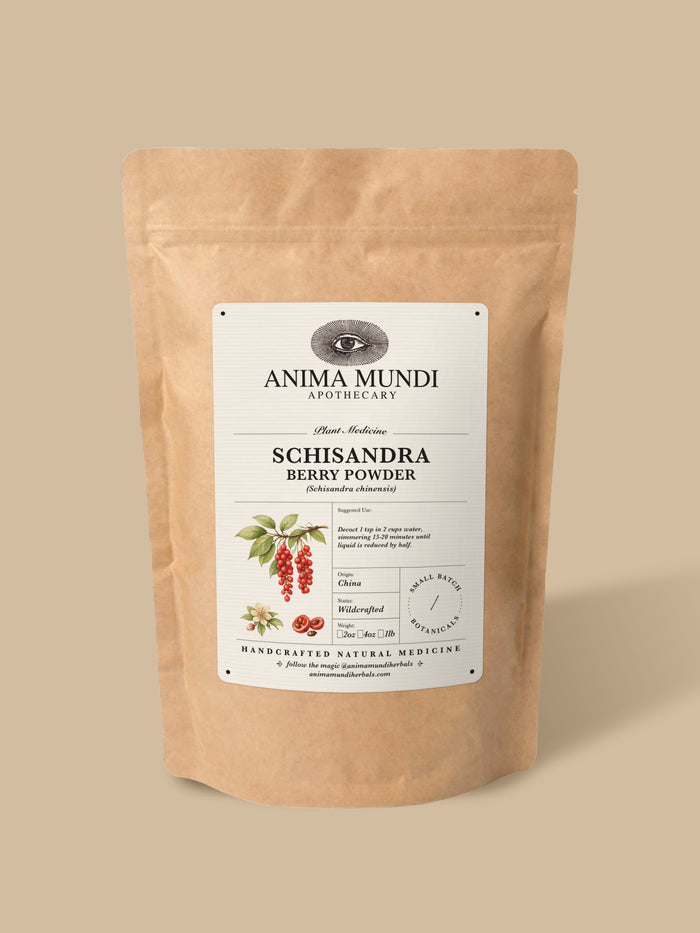 A stand-up kraft paper pouch of Anima Mundi Apothecary Schisandra Berry Powder, featuring a white label with botanical illustrations, set against a solid beige background.