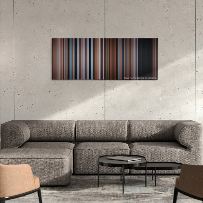 The Accountant color palette canvas on a concrete wall above a gray sectional sofa