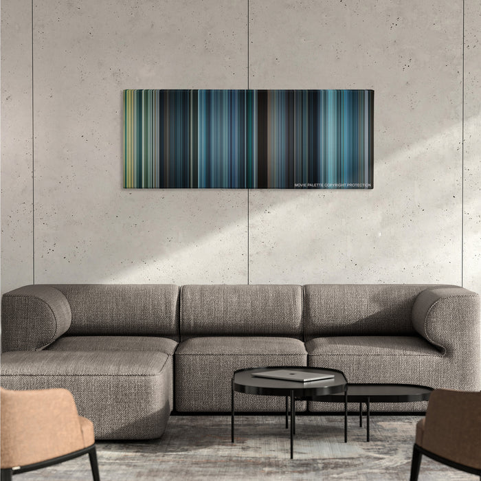 The Expendables 2 color palette canvas on a concrete wall above a gray sectional sofa